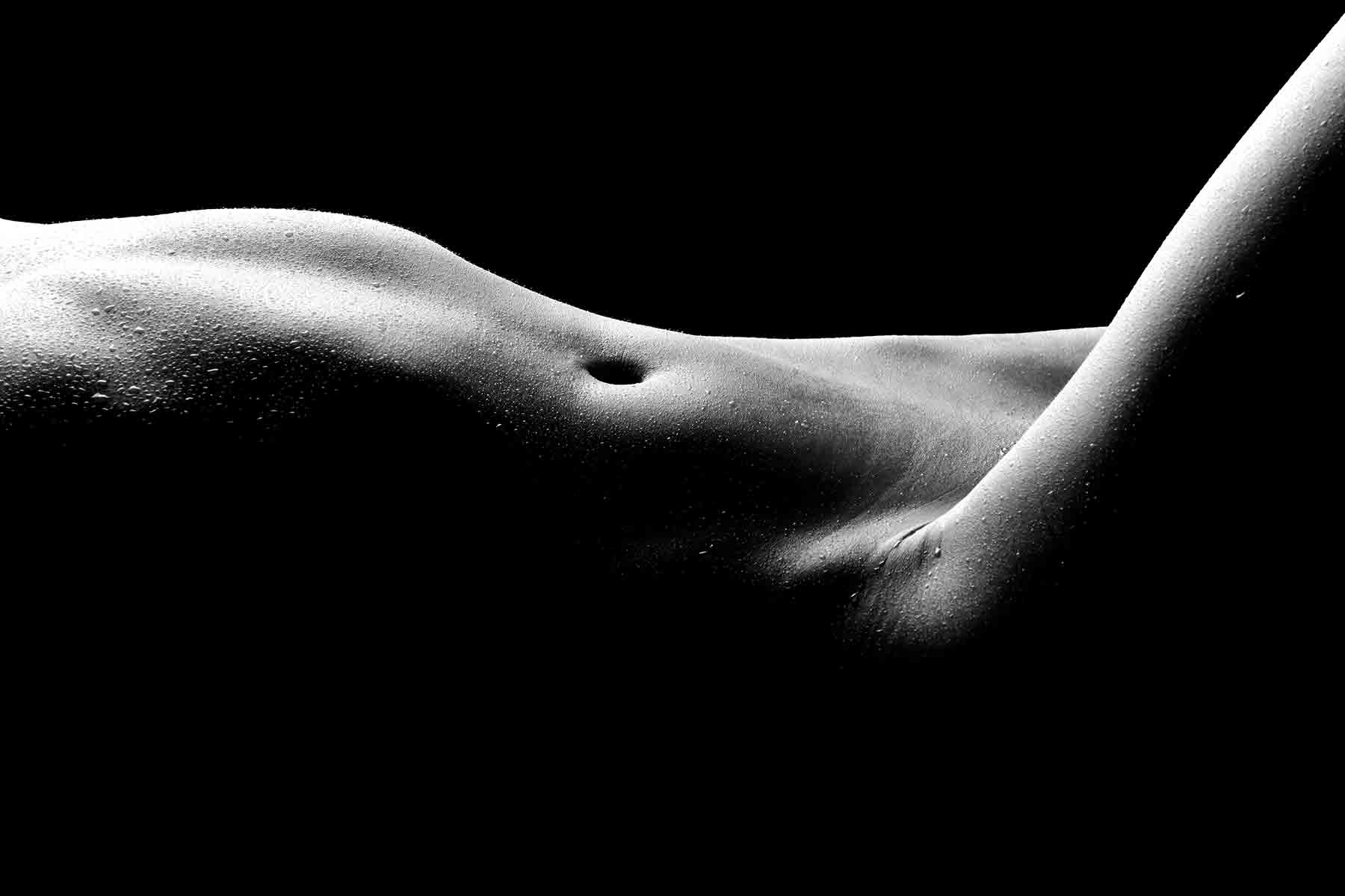 black and white photograph of a nude female form focusing on the abdomen